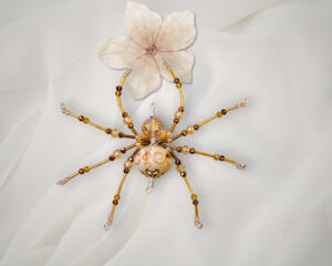 Elegant handmade beaded spider in golden hues with sparkling amber and clear crystal beads